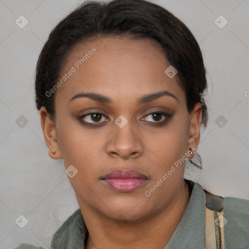 Joyful black young-adult female with long  brown hair and brown eyes