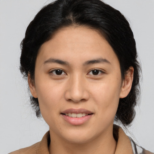 Joyful asian young-adult female with medium  brown hair and brown eyes