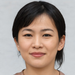 Joyful asian young-adult female with medium  black hair and brown eyes