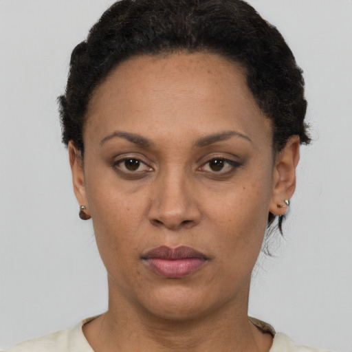 Joyful latino adult female with short  black hair and brown eyes