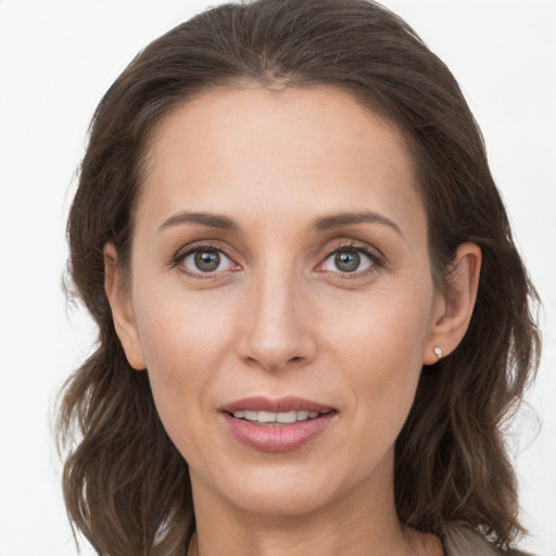 Joyful white young-adult female with long  brown hair and grey eyes