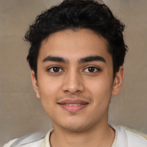 Joyful latino young-adult male with short  brown hair and brown eyes