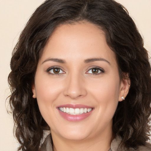 Joyful white young-adult female with long  brown hair and brown eyes