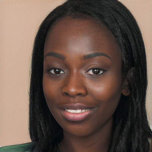 Joyful black young-adult female with long  black hair and brown eyes