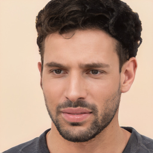 Joyful white young-adult male with short  black hair and brown eyes