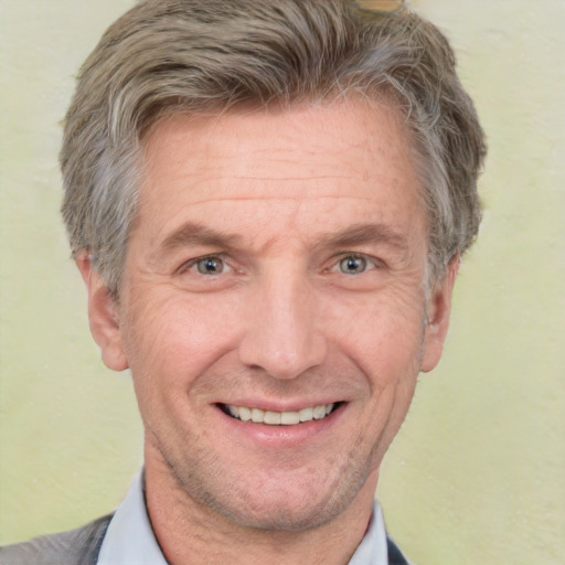 Joyful white middle-aged male with short  brown hair and brown eyes