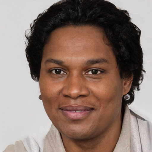 Joyful black adult female with short  brown hair and brown eyes