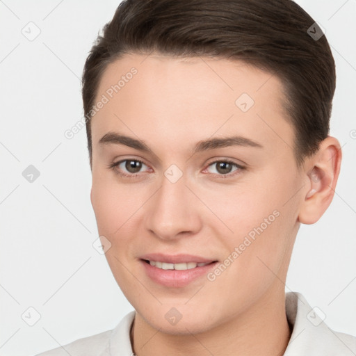 Joyful white young-adult female with short  brown hair and brown eyes