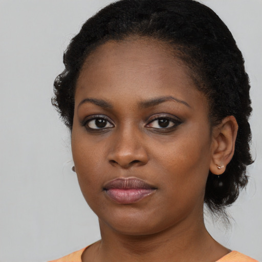 Neutral black young-adult female with medium  black hair and brown eyes