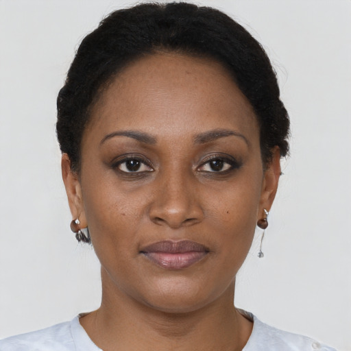 Joyful black adult female with short  brown hair and brown eyes