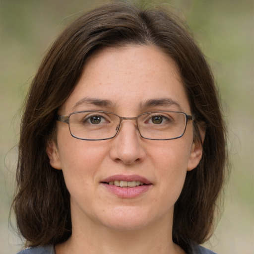 Joyful white adult female with medium  brown hair and green eyes