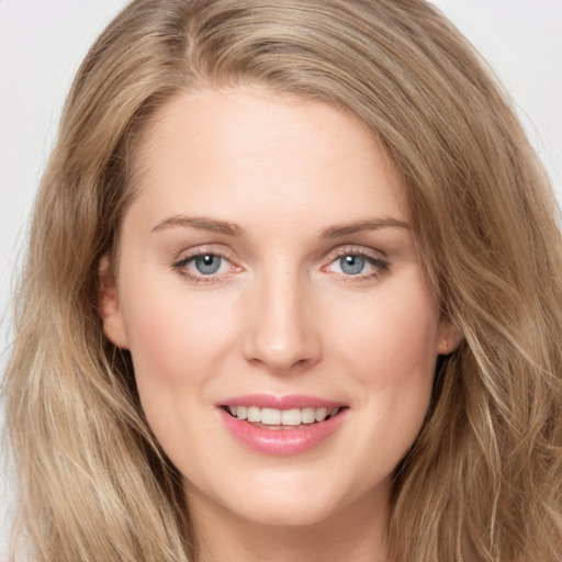 Joyful white young-adult female with long  brown hair and blue eyes