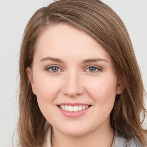 Joyful white young-adult female with long  brown hair and grey eyes