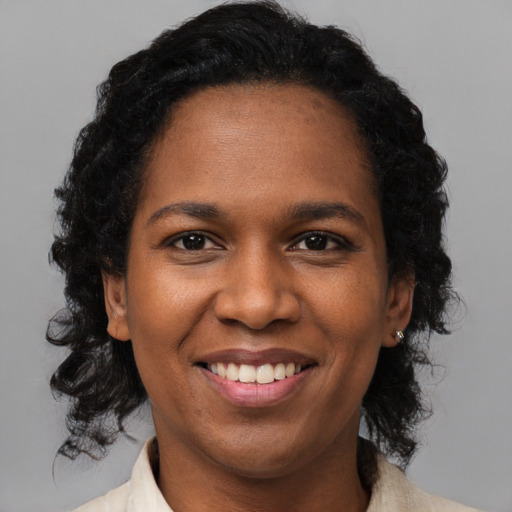 Joyful black young-adult female with medium  brown hair and brown eyes