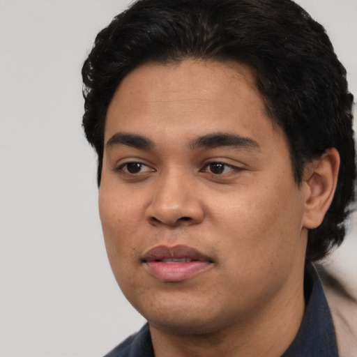 Joyful white young-adult male with short  black hair and brown eyes