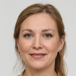 Joyful white adult female with long  brown hair and grey eyes