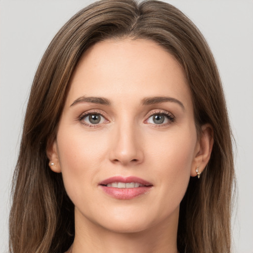 Joyful white young-adult female with long  brown hair and grey eyes