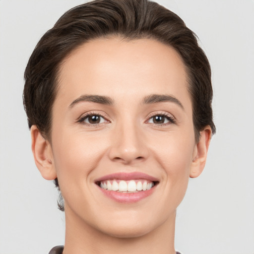 Joyful white young-adult female with short  brown hair and brown eyes