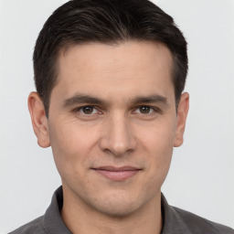 Joyful white young-adult male with short  brown hair and brown eyes