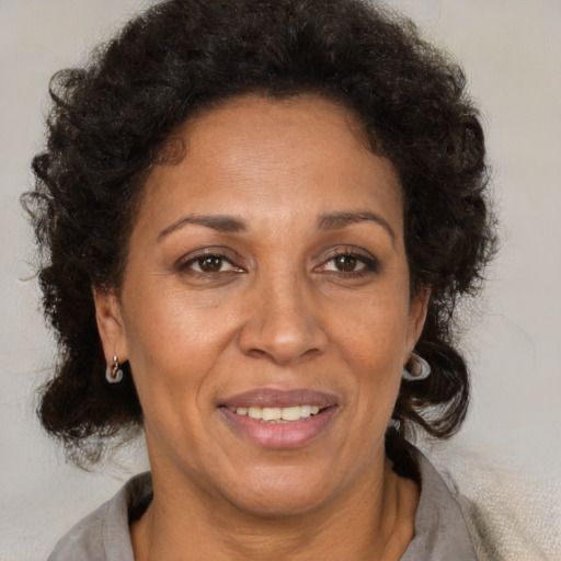 Joyful latino adult female with short  brown hair and brown eyes