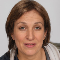 Joyful white adult female with medium  brown hair and brown eyes