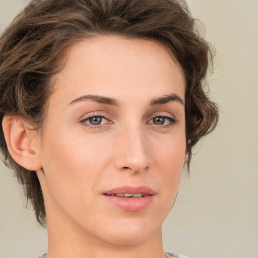 Joyful white young-adult female with medium  brown hair and green eyes