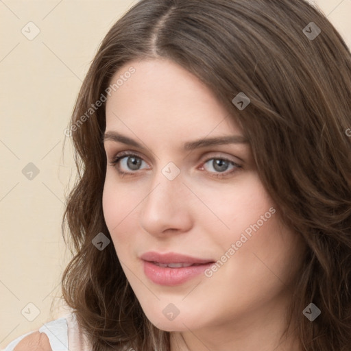 Joyful white young-adult female with medium  brown hair and green eyes