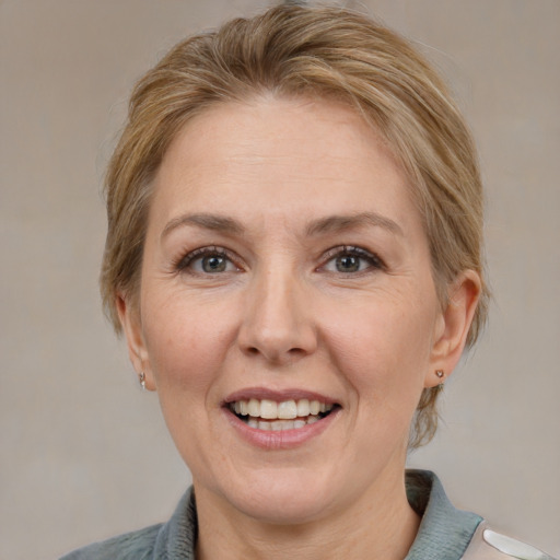 Joyful white adult female with medium  brown hair and grey eyes