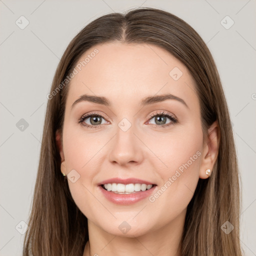 Joyful white young-adult female with long  brown hair and green eyes