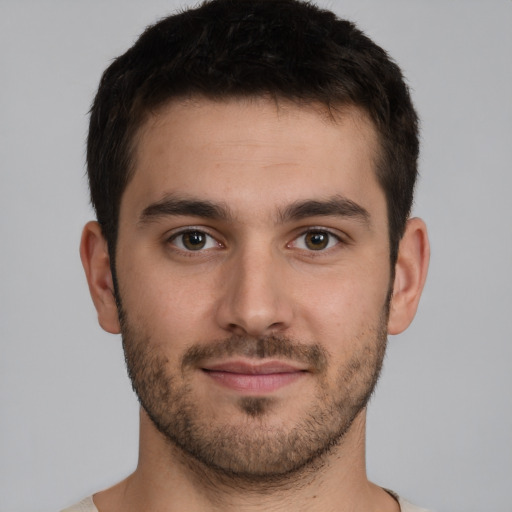 Joyful white young-adult male with short  brown hair and brown eyes