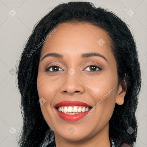 Joyful latino young-adult female with long  black hair and brown eyes