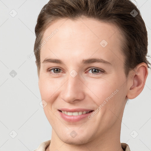 Joyful white young-adult female with short  brown hair and grey eyes