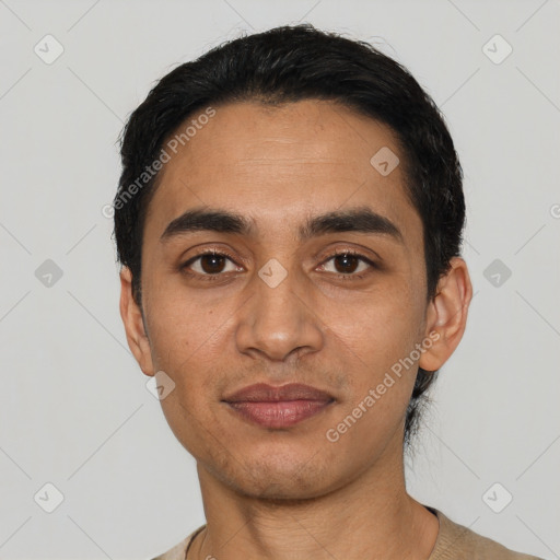 Joyful latino young-adult male with short  black hair and brown eyes