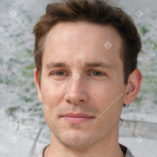 Joyful white adult male with short  brown hair and grey eyes