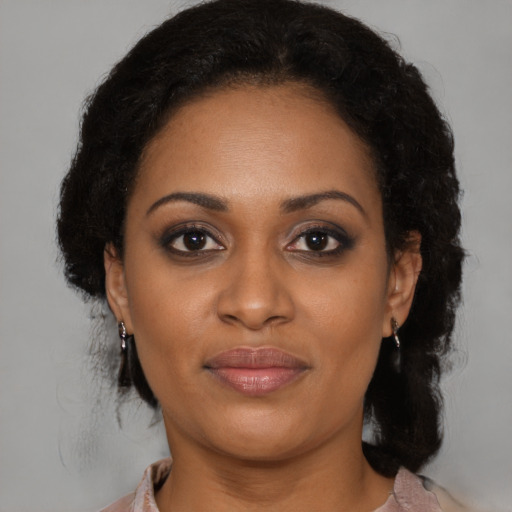 Joyful black young-adult female with medium  brown hair and brown eyes