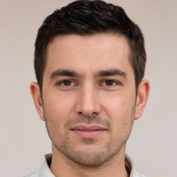 Joyful white young-adult male with short  brown hair and brown eyes