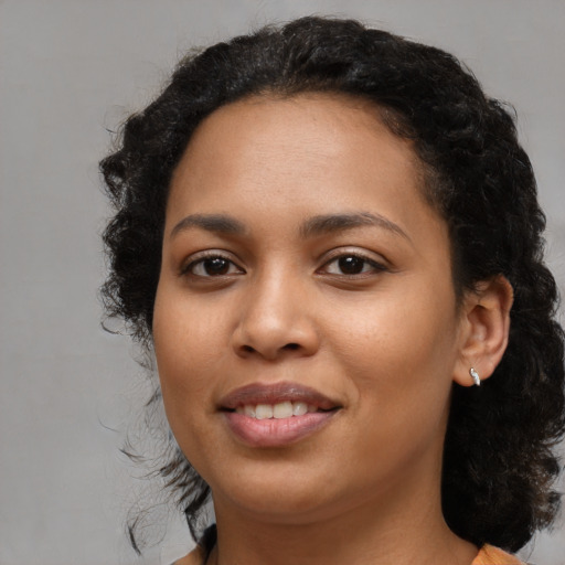 Joyful latino young-adult female with medium  black hair and brown eyes