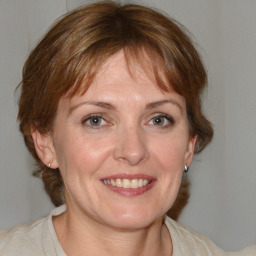 Joyful white adult female with medium  brown hair and blue eyes