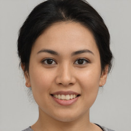 Joyful asian young-adult female with medium  brown hair and brown eyes