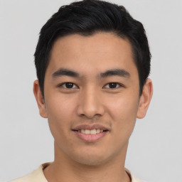 Joyful asian young-adult male with short  black hair and brown eyes