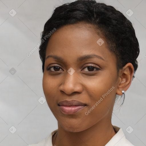 Joyful black young-adult female with short  black hair and brown eyes