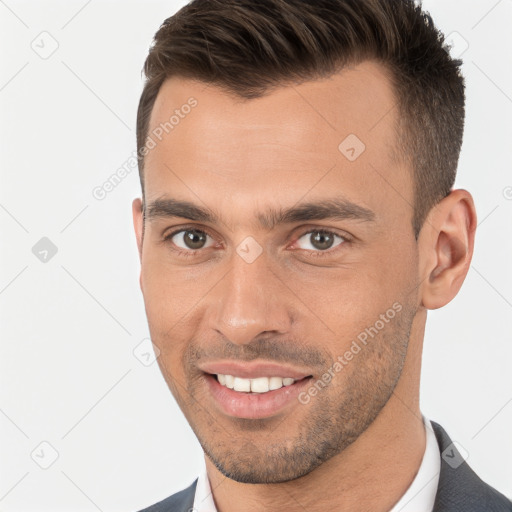 Joyful white young-adult male with short  brown hair and brown eyes