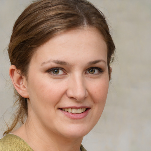 Joyful white young-adult female with medium  brown hair and grey eyes