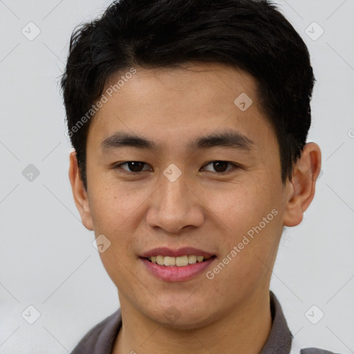 Joyful asian young-adult male with short  brown hair and brown eyes