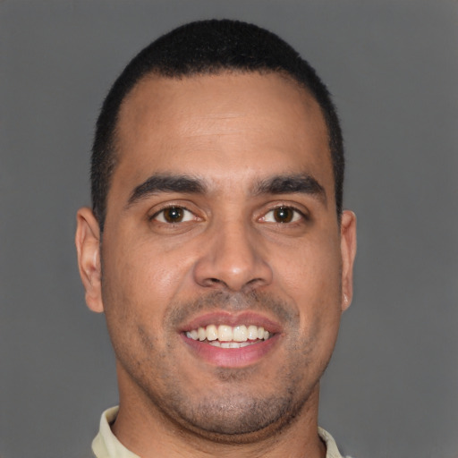Joyful latino young-adult male with short  brown hair and brown eyes