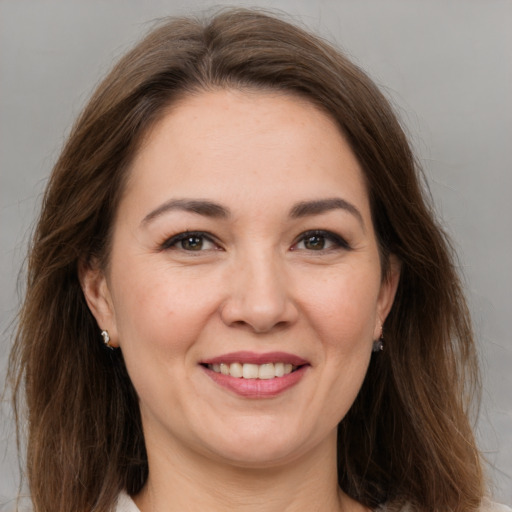 Joyful white adult female with medium  brown hair and brown eyes