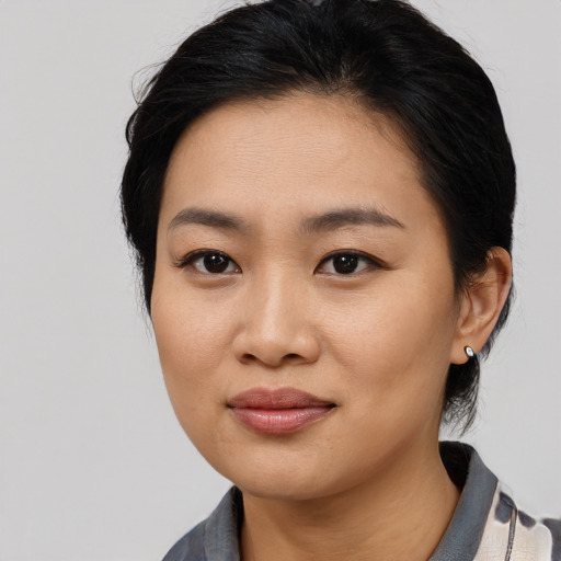 Joyful asian young-adult female with medium  black hair and brown eyes