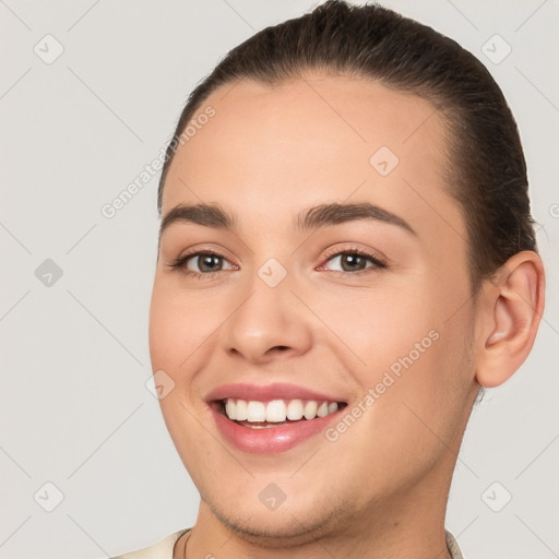 Joyful white young-adult female with short  brown hair and brown eyes