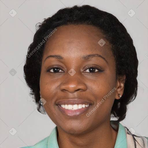 Joyful black young-adult female with long  black hair and brown eyes