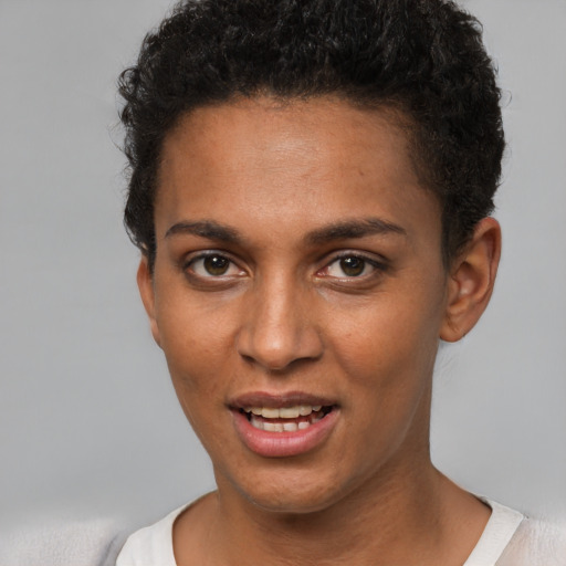 Joyful black young-adult female with short  brown hair and brown eyes